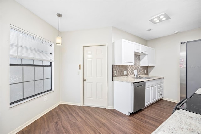 kitchen featuring dark hardwood / wood-style flooring, stainless steel appliances, sink, white cabinets, and hanging light fixtures