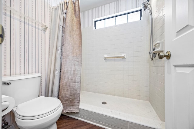 bathroom with toilet, wood-type flooring, and walk in shower