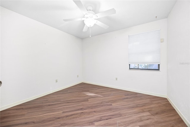 unfurnished room featuring ceiling fan and dark hardwood / wood-style flooring