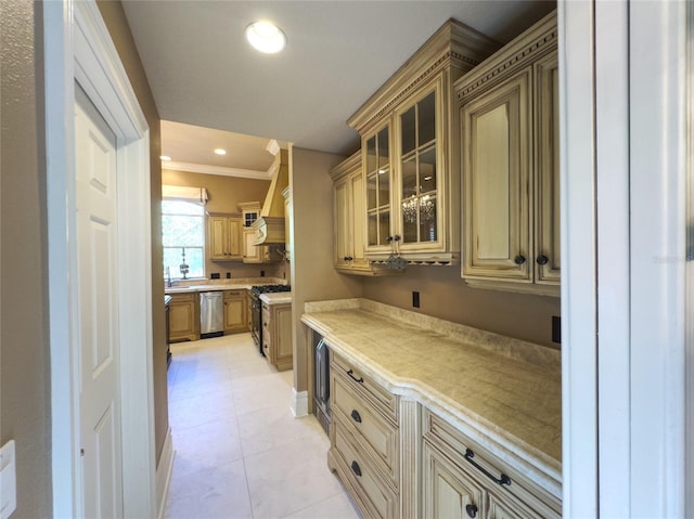 kitchen with ornamental molding, stainless steel appliances, and light tile patterned floors