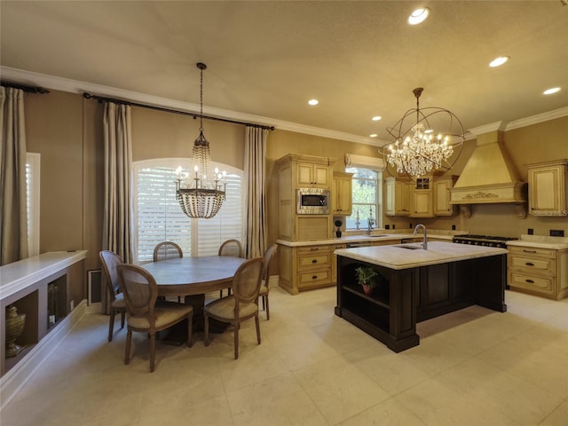 kitchen featuring premium range hood, stainless steel microwave, ornamental molding, and an island with sink