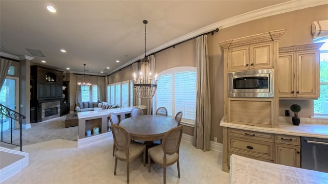 dining space with crown molding, light tile patterned floors, and an inviting chandelier