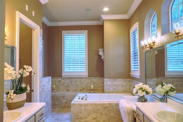 bathroom featuring a chandelier, vanity, crown molding, and tiled tub