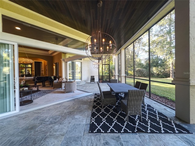 unfurnished sunroom featuring wood ceiling and a notable chandelier