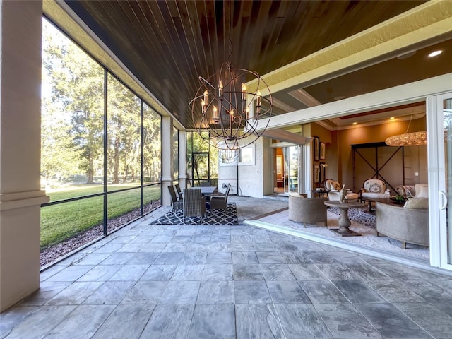 unfurnished sunroom featuring an inviting chandelier and wood ceiling