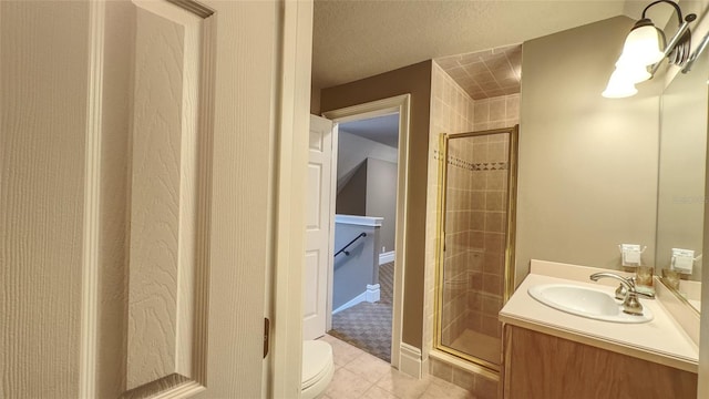 bathroom with tile patterned floors, vanity, toilet, and an enclosed shower