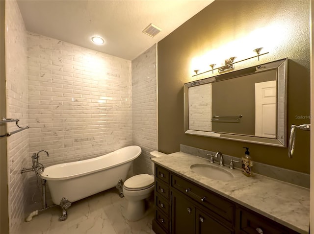 bathroom featuring a washtub, toilet, and vanity