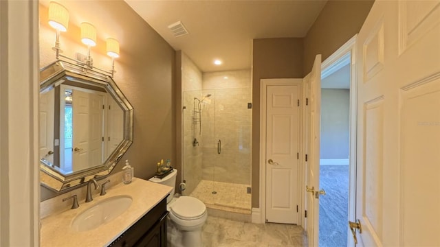 bathroom featuring vanity, toilet, and a shower with door