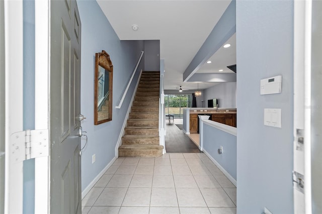 tiled foyer entrance featuring ceiling fan