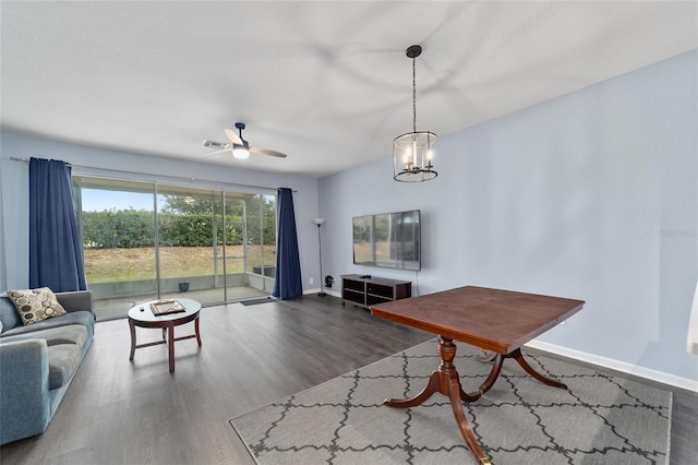 living room with ceiling fan with notable chandelier and hardwood / wood-style flooring