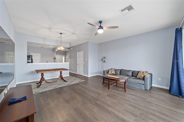 living room with ceiling fan and hardwood / wood-style flooring