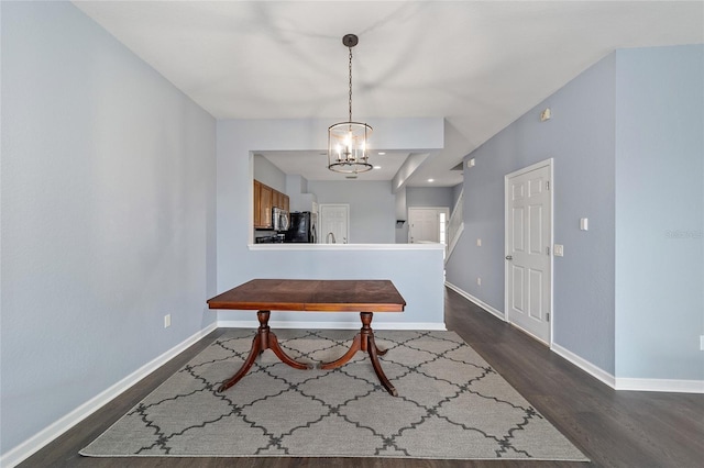 dining area featuring a notable chandelier and dark hardwood / wood-style floors