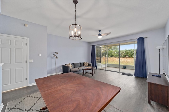 interior space with wood-type flooring and ceiling fan with notable chandelier