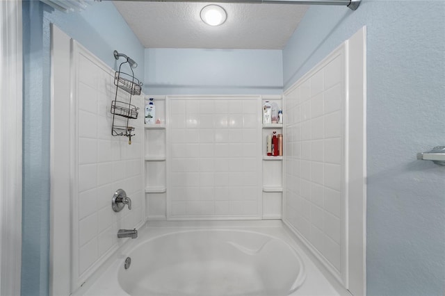 bathroom with  shower combination and a textured ceiling