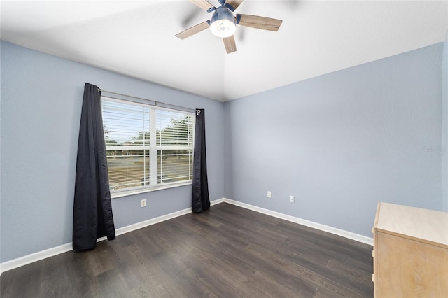 spare room featuring dark hardwood / wood-style floors and ceiling fan