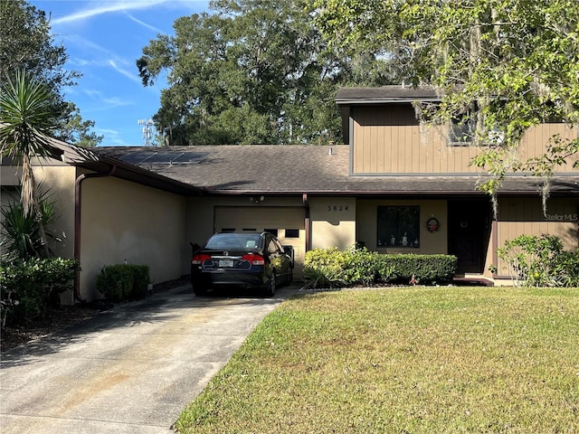 3824 NE 17th Street Cir, Ocala, FL 34470 - view of front of property with roof with shingles, a front lawn, driveway, a garage, and stucco siding