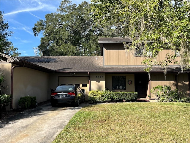 3824 NE 17th Street Cir, Ocala, FL 34470 - view of front of property featuring stucco siding, concrete driveway, a front lawn, and a garage