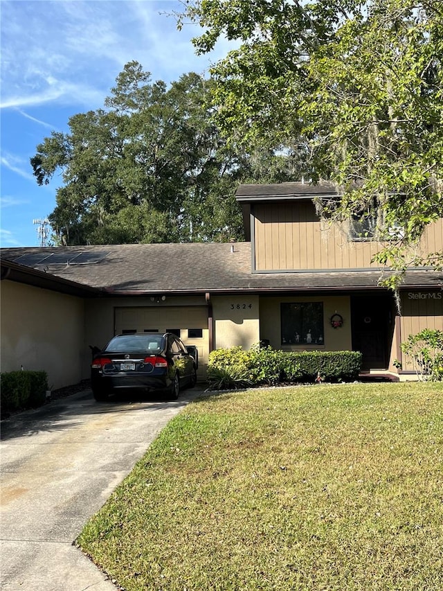 3824 NE 17th Street Cir, Ocala, FL 34470 - view of front of property featuring stucco siding, an attached garage, a front yard, and concrete driveway
