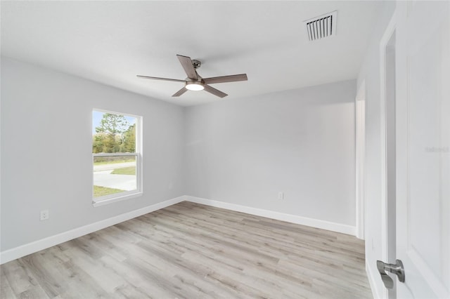 unfurnished room with light wood finished floors, baseboards, visible vents, and ceiling fan