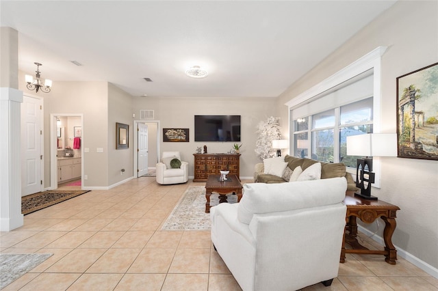 tiled living room featuring a chandelier