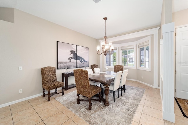 tiled dining space featuring a notable chandelier