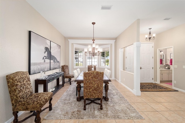 dining room with an inviting chandelier and light tile patterned floors