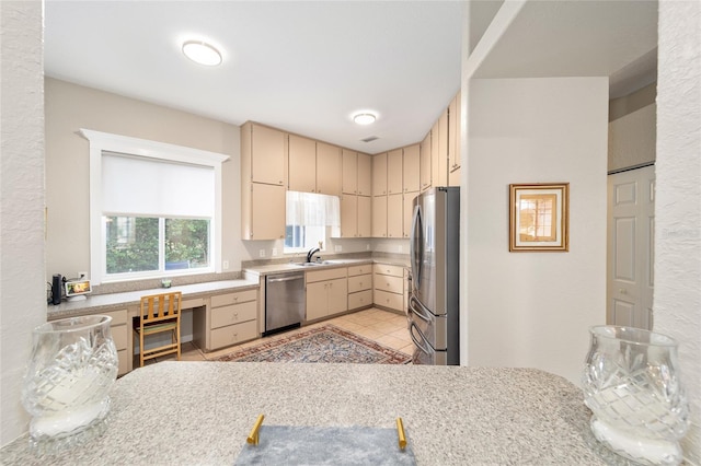 kitchen featuring sink, light tile patterned floors, and stainless steel appliances