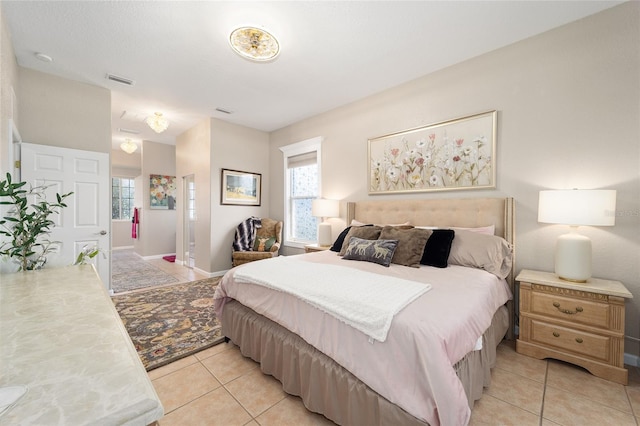 tiled bedroom with multiple windows