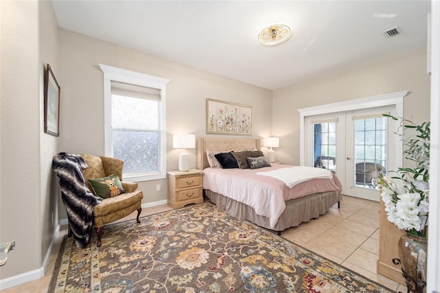 tiled bedroom with access to exterior and french doors