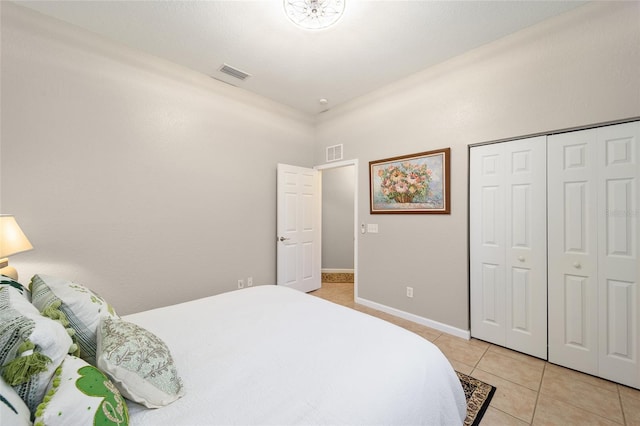 tiled bedroom featuring a closet