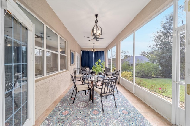 sunroom / solarium featuring ceiling fan with notable chandelier