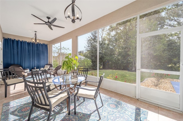 sunroom / solarium with ceiling fan with notable chandelier