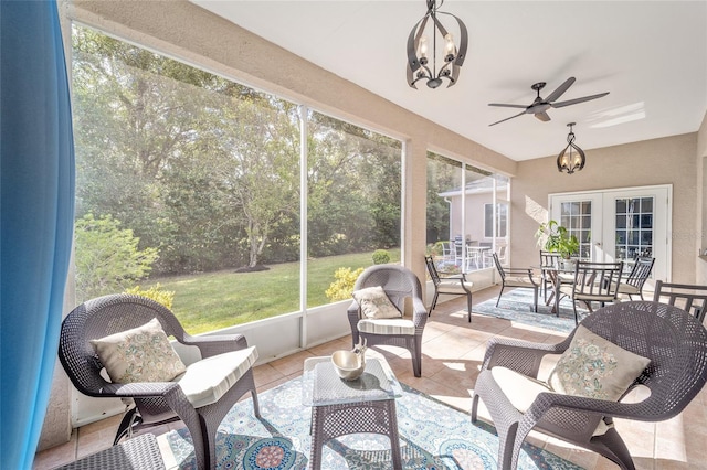 sunroom / solarium featuring ceiling fan and french doors