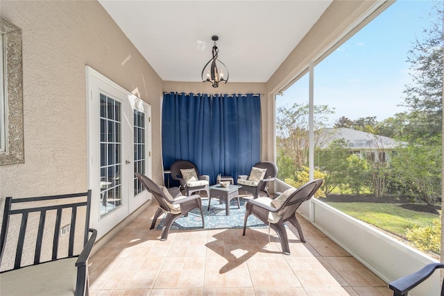 sunroom / solarium with french doors and a chandelier