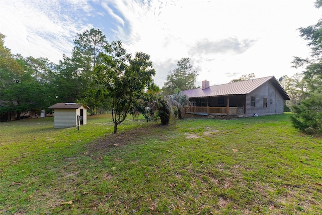 view of yard featuring a porch and a storage unit