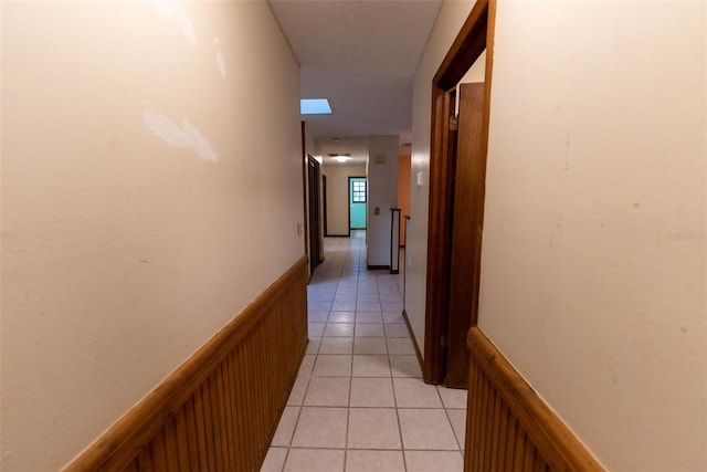 corridor featuring light tile patterned floors