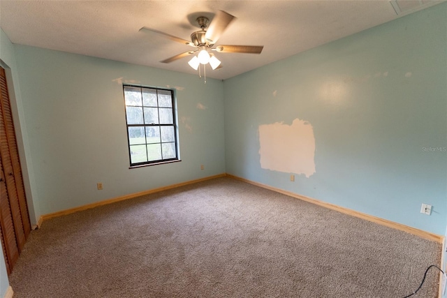 carpeted empty room with ceiling fan