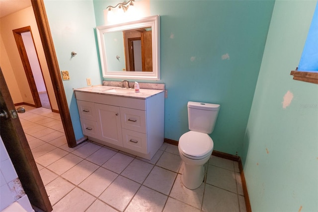 bathroom featuring tile patterned flooring, vanity, and toilet