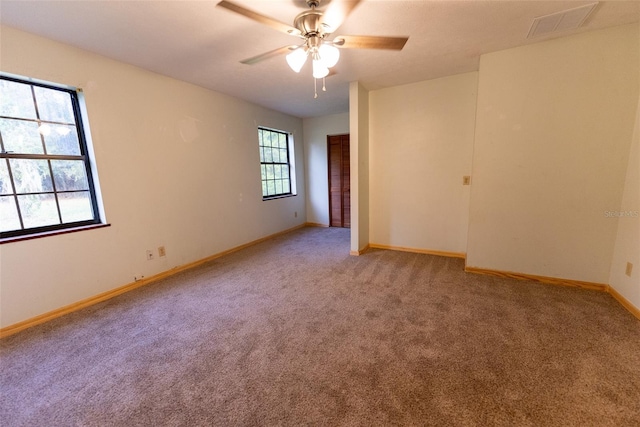 carpeted empty room featuring ceiling fan