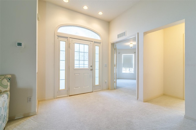 entryway with light colored carpet