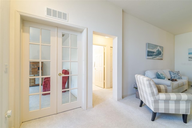 living area featuring light colored carpet