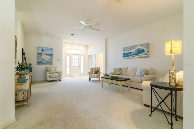 living room featuring ceiling fan and light colored carpet