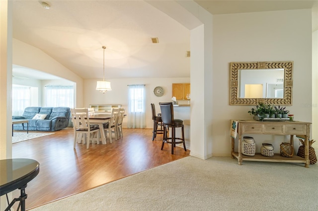 dining room featuring hardwood / wood-style flooring and lofted ceiling