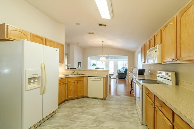 kitchen featuring pendant lighting, lofted ceiling, white appliances, sink, and kitchen peninsula