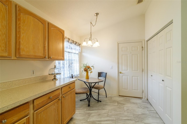 kitchen with hanging light fixtures, vaulted ceiling, and a notable chandelier