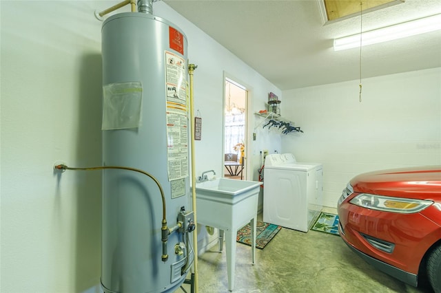 laundry room featuring a textured ceiling, sink, gas water heater, and washing machine and clothes dryer