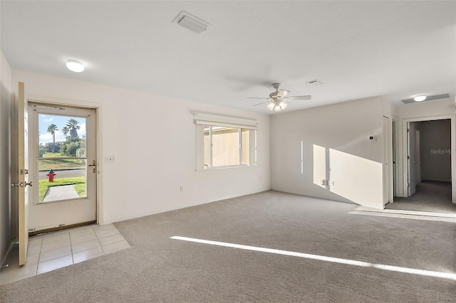 spare room with ceiling fan and light colored carpet