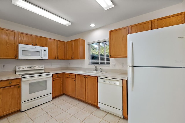 kitchen with white appliances, sink, and light tile patterned floors