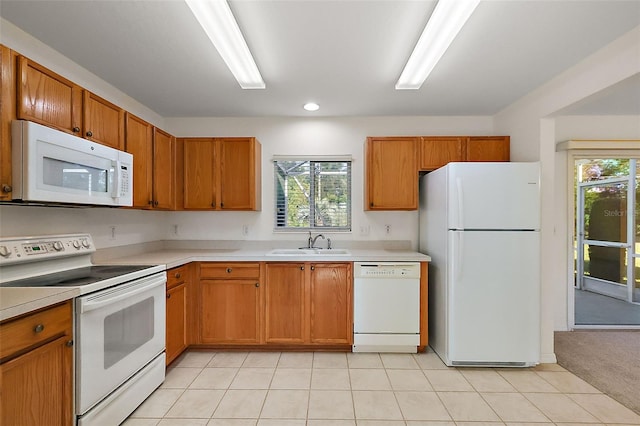 kitchen featuring white appliances, light colored carpet, a wealth of natural light, and sink