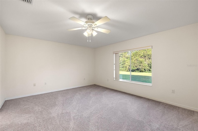 empty room featuring carpet floors and ceiling fan